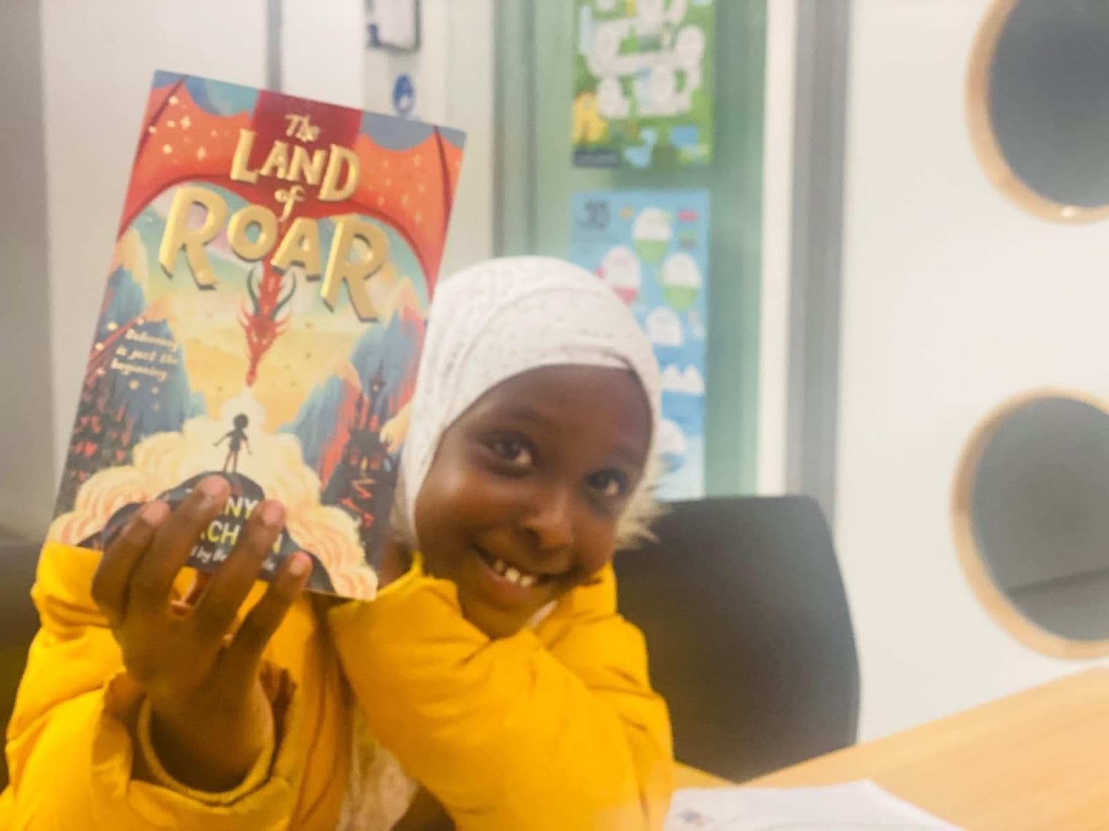 Student smiling with a reading book at LEC Education