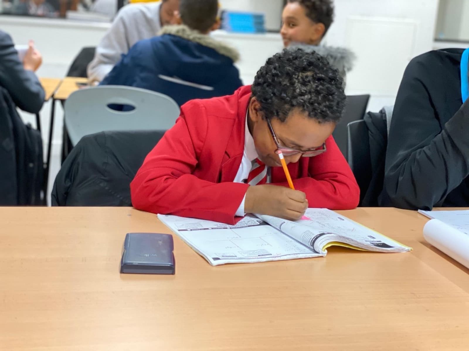 Students learning together in a small group at LEC Education